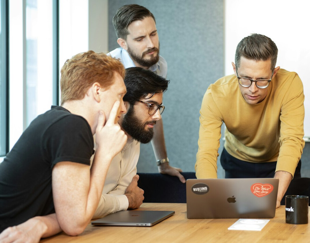corporate team discussing code